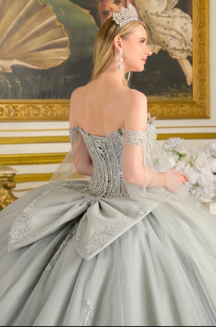 Detachable cape sleeves frame the W-neckline corset bodice of this enchanting ball gown. GL3711 BY ELIZABETH K