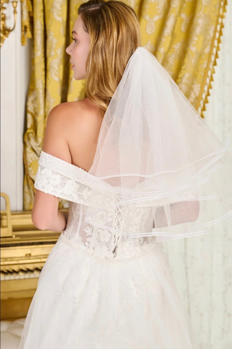 Make a breathtaking entrance in this intricately detailed off-shoulder wedding gown. GL3827 BY GLORIA