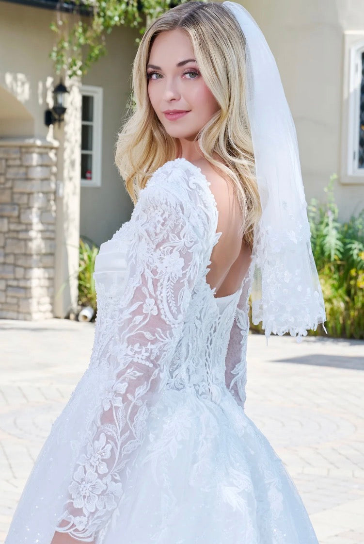 This elegant ball gown wedding dress features a V-neckline. GL3820 GLS BY GLORIA