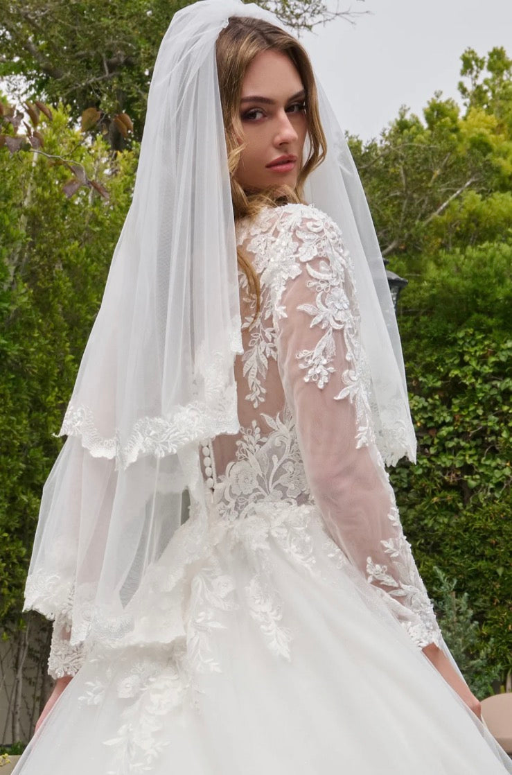 This ballgown features a boat neckline bodice with elegant long sleeves, creating a timeless and graceful silhouette. GL3844 BY GLORIA