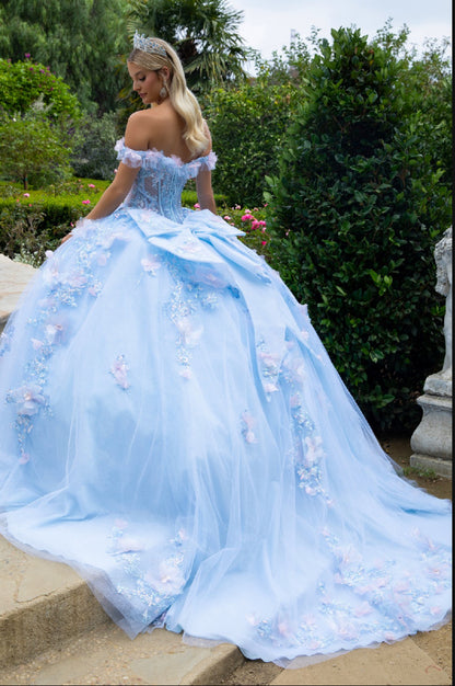 The v-neckline, sheer corset bodice connects to off-shoulder straps with the help of 3D flower appliques and ruffles. GL3555 GLS by Gloria