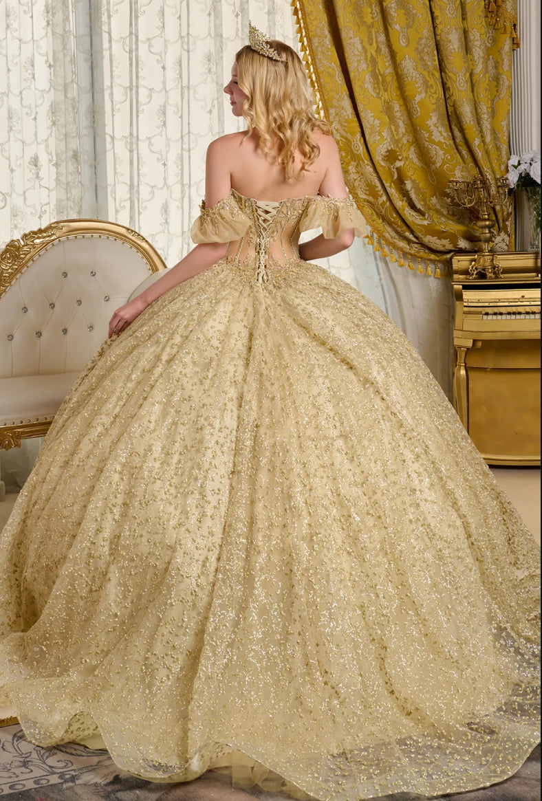 This ball gown showcases a sheer, bejeweled corset bodice paired with off-the-shoulder bubble hem sleeves. GL3632 BY ELIZABETH K