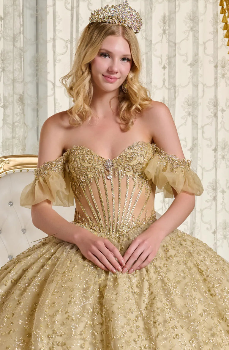This ball gown showcases a sheer, bejeweled corset bodice paired with off-the-shoulder bubble hem sleeves. GL3632 BY ELIZABETH K