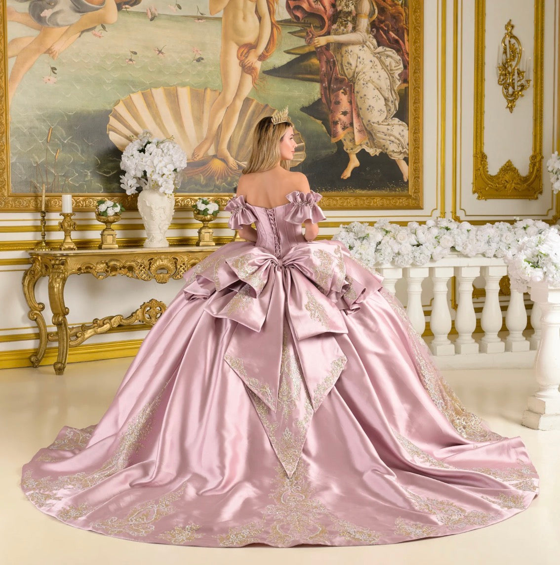 This quinceañera ball gown features off-shoulder ruffle cuff sleeves that frame a V-neckline corset bodice. GL3803 BY ELIZABETH K
