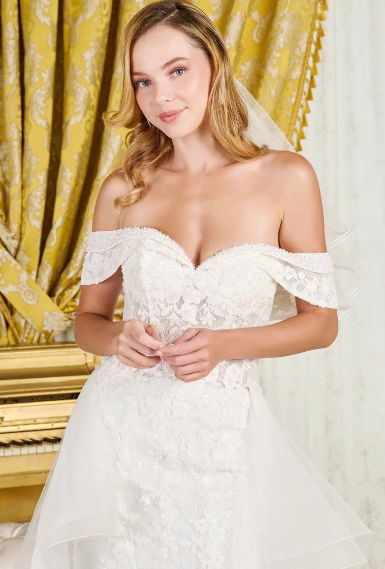 Make a breathtaking entrance in this intricately detailed off-shoulder wedding gown.  GL3827 BY GLORIA