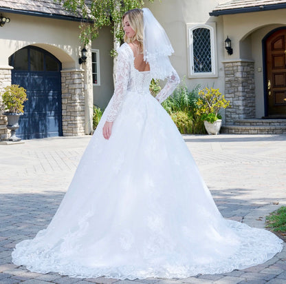 This elegant ball gown wedding dress features a V-neckline. GL3820 GLS BY GLORIA