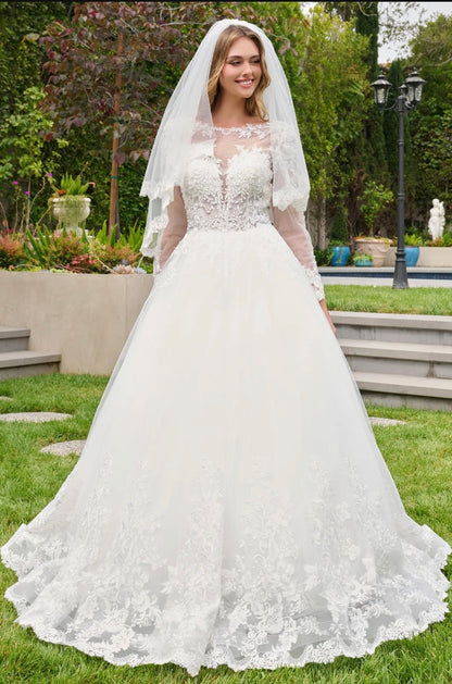This ballgown features a boat neckline bodice with elegant long sleeves, creating a timeless and graceful silhouette. GL3844 BY GLORIA