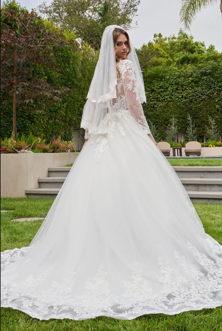 This ballgown features a boat neckline bodice with elegant long sleeves, creating a timeless and graceful silhouette. GL3844 BY GLORIA