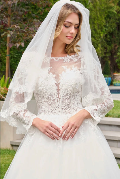 This ballgown features a boat neckline bodice with elegant long sleeves, creating a timeless and graceful silhouette. GL3844 BY GLORIA